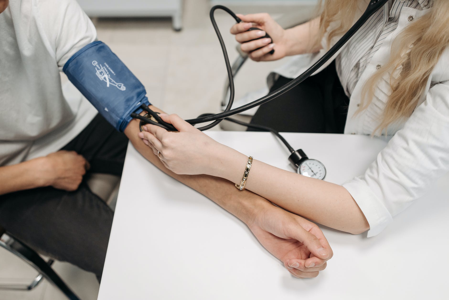 A picture of a patient having their blood pressure checked at the clinic. 