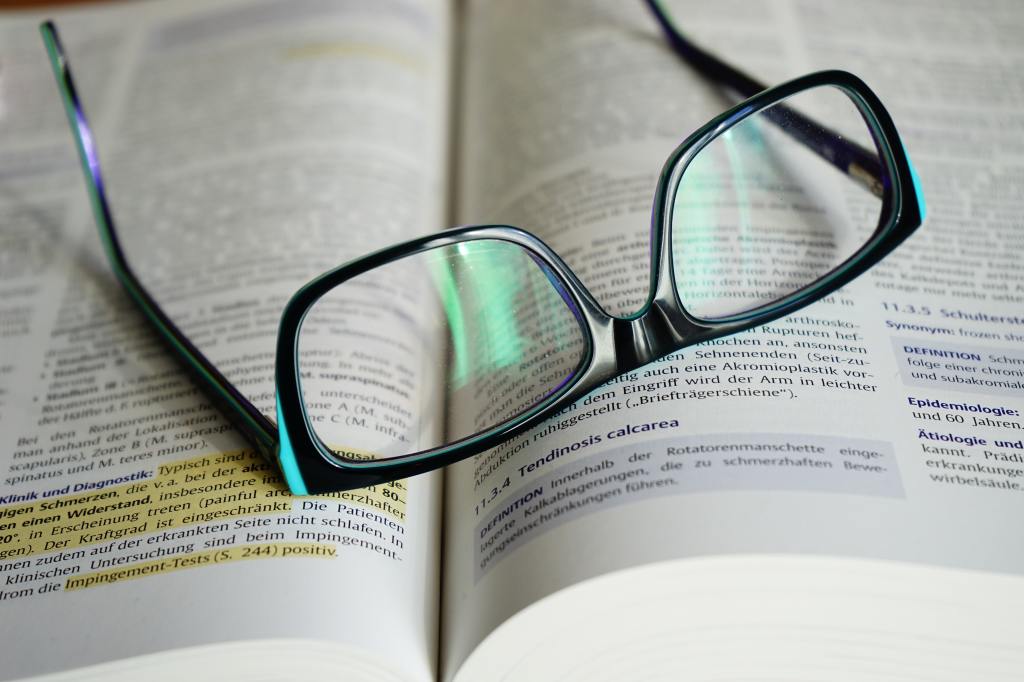 Picture of glasses on a textbook. 